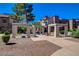 Walkway featuring decorative trellis structures, mature trees, and lush landscaping, creating a welcoming atmosphere at 2966 Juniper Hills Blvd # 102, Las Vegas, NV 89142