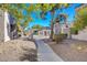 Walkway with decorative trellis feature and mature landscaping, enhancing the community's aesthetic appeal at 2966 Juniper Hills Blvd # 102, Las Vegas, NV 89142