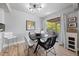 Stylish dining area with hardwood floors, a modern light fixture, and sliding glass doors to a patio at 320 Shadybrook Ln # D, Las Vegas, NV 89107