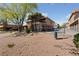Exterior of a two-story unit with outside stairwell and row of garages in a community, desert landscape at 320 Shadybrook Ln # D, Las Vegas, NV 89107