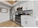 Kitchen with stainless appliances, white cabinetry and grey subway tile backsplash at 320 Shadybrook Ln # D, Las Vegas, NV 89107