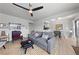 Comfortable living room featuring hardwood floors, gray walls, modern decor, and a contemporary ceiling fan at 320 Shadybrook Ln # D, Las Vegas, NV 89107