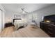 Bright main bedroom features a ceiling fan, bedside tables and a dresser at 320 Shadybrook Ln # D, Las Vegas, NV 89107