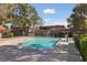 A community swimming pool with a concrete pool deck, pergola, and landscaping at 320 Shadybrook Ln # D, Las Vegas, NV 89107