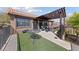 This rooftop patio features a pergola, astro turf, wrought iron railing, and an outdoor seating area at 320 Shadybrook Ln # D, Las Vegas, NV 89107