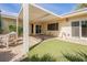 Charming backyard featuring a covered patio, artificial turf, and serene landscaping at 3287 Southridge Ave, Las Vegas, NV 89121