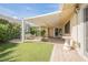 Serene backyard with a covered patio, desert landscaping, and charming outdoor space at 3287 Southridge Ave, Las Vegas, NV 89121