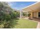 Well-maintained backyard with covered patio, artificial turf, and vibrant desert landscaping at 3287 Southridge Ave, Las Vegas, NV 89121