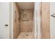 Bathroom features a stone-tiled standing shower with supportive metal bars for safety and accessibility at 3287 Southridge Ave, Las Vegas, NV 89121