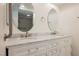 Double sink bathroom vanity with marble countertop, white cabinets, and modern fixtures at 3287 Southridge Ave, Las Vegas, NV 89121