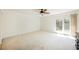 Spacious bedroom with neutral carpet, ceiling fan, and sliding glass doors to the backyard at 3287 Southridge Ave, Las Vegas, NV 89121
