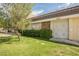 View of the house featuring well-maintained lawn, mature landscaping, and a charming brick accent wall at 3287 Southridge Ave, Las Vegas, NV 89121