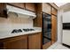 This kitchen is equipped with white countertops, a gas stove, and dual ovens at 3287 Southridge Ave, Las Vegas, NV 89121