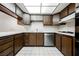 Cozy kitchen featuring wood cabinetry, white countertops, and stainless steel appliances at 3287 Southridge Ave, Las Vegas, NV 89121