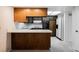 A charming kitchen with a breakfast bar, white appliances, and wooden cabinets at 3287 Southridge Ave, Las Vegas, NV 89121