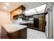 Functional kitchen featuring wood cabinetry, white countertops, and essential appliances for modern living at 3287 Southridge Ave, Las Vegas, NV 89121