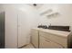 Functional laundry area with storage cabinet, shelving and essential appliances at 3287 Southridge Ave, Las Vegas, NV 89121