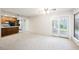 Spacious living room with a light patterned carpet and sliding doors to the outside patio at 3287 Southridge Ave, Las Vegas, NV 89121