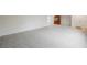 A spacious living area showcasing neutral walls and patterned carpeting, leading into an adjacent space at 3287 Southridge Ave, Las Vegas, NV 89121