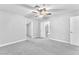 Bright bedroom with neutral carpet, ceiling fan and a view into an ensuite bathroom at 3929 Torsby Pl # 3929, Las Vegas, NV 89119