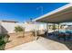 Backyard featuring a covered patio, desert landscaping, block wall, and seating around a table at 4121 Satinwood Dr, Las Vegas, NV 89147