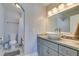 Well-lit bathroom featuring a modern vessel sink, grey vanity, and shower with a white curtain at 4121 Satinwood Dr, Las Vegas, NV 89147