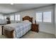 Charming bedroom with a classic bed frame, soft carpet, and bright natural light at 4121 Satinwood Dr, Las Vegas, NV 89147