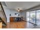 Open dining area with a ceiling fan, bar table, and sliding glass doors to the patio at 4121 Satinwood Dr, Las Vegas, NV 89147