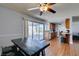 Dining area with an overhead fan, wood floors, and sliding door access to outdoor patio at 4121 Satinwood Dr, Las Vegas, NV 89147