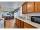 An open kitchen view with wooden cabinets, white counter tops and stainless steel appliances at 4121 Satinwood Dr, Las Vegas, NV 89147