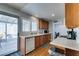 Bright kitchen with white counters, stainless appliances, wood cabinets, and backyard access at 4121 Satinwood Dr, Las Vegas, NV 89147