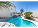 Backyard pool and spa area with desert landscaping, a white fence, and a covered patio at 4121 Satinwood Dr, Las Vegas, NV 89147