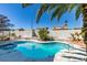 Backyard pool with a spa, desert landscaping, and a privacy wall at 4121 Satinwood Dr, Las Vegas, NV 89147