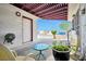 Cozy covered patio area ideal for outdoor dining and relaxation, complete with furniture and access to yard at 416 Wyoming St, Boulder City, NV 89005