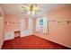 Comfortable bedroom with red carpet, built-in shelving, and window for natural light at 416 Wyoming St, Boulder City, NV 89005