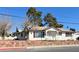 Charming single-story home with a well-maintained front yard and a stone retaining wall for added curb appeal at 416 Wyoming St, Boulder City, NV 89005