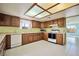 Functional kitchen featuring cabinetry, white appliances, and tiled flooring at 416 Wyoming St, Boulder City, NV 89005