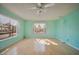Bright living room featuring neutral paint, laminate flooring, two windows and ample natural light at 416 Wyoming St, Boulder City, NV 89005