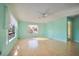 Bright living room featuring hardwood floors, natural light, and ceiling fan at 416 Wyoming St, Boulder City, NV 89005
