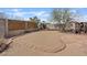 Fenced in backyard, featuring desert landscaping and a playhouse at 429 Sunburst Dr, Henderson, NV 89002