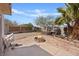 Backyard area featuring a cozy fire pit, neutral landscaping and a playhouse at 429 Sunburst Dr, Henderson, NV 89002