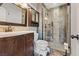 Bathroom featuring a glass shower, decorative tile, wooden vanity, mirror and a wall cabinet at 429 Sunburst Dr, Henderson, NV 89002