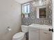 Stylized powder room featuring modern tiling, contemporary fixtures and window at 429 Sunburst Dr, Henderson, NV 89002