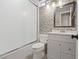 Updated bathroom featuring a shower-tub combo, patterned backsplash, and modern vanity with a framed mirror at 429 Sunburst Dr, Henderson, NV 89002