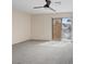 Spacious bedroom with neutral walls and gray carpet, featuring a sliding glass door leading to the exterior at 429 Sunburst Dr, Henderson, NV 89002