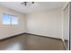 Well lit bedroom with hardwood floors and large window at 429 Sunburst Dr, Henderson, NV 89002