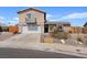 Two-story home featuring a balcony above the garage, complemented by a well-maintained front yard at 429 Sunburst Dr, Henderson, NV 89002