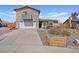 Charming two-story house with a garage, balcony, xeriscaping, and a view of the home's address at 429 Sunburst Dr, Henderson, NV 89002