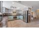 Charming kitchen features updated stainless appliances, custom cabinetry, and complementary backsplash at 429 Sunburst Dr, Henderson, NV 89002