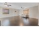 Bright living room with hardwood floors, dual ceiling fans, many windows and a neutral-colored sofa at 429 Sunburst Dr, Henderson, NV 89002